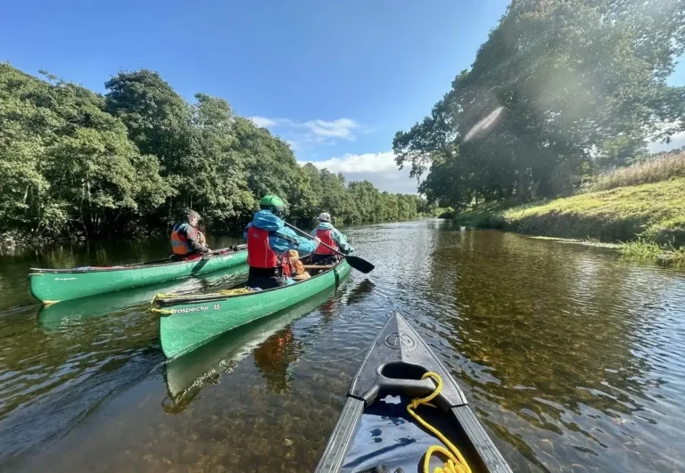 Paddlers on a River Tweed Canoe Trip